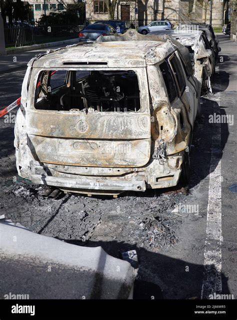 Thematic photo of a burned-out car on a residential street