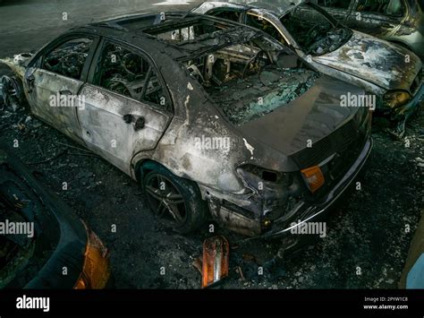 Photo of a burned out Mercedes and Chrysler cars on a residential property