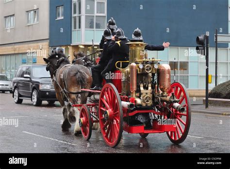 Historical photo of OSP Luzino unit with an old fire engine or the horse-drawn pump