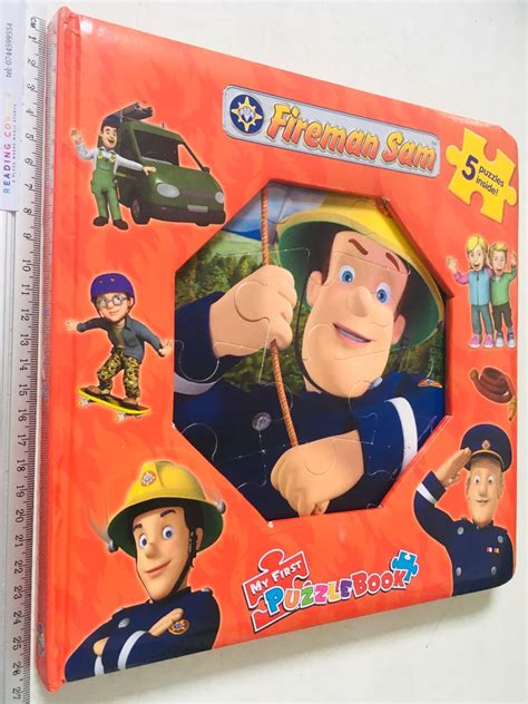 Child playing with a Fireman Sam puzzle or coloring book