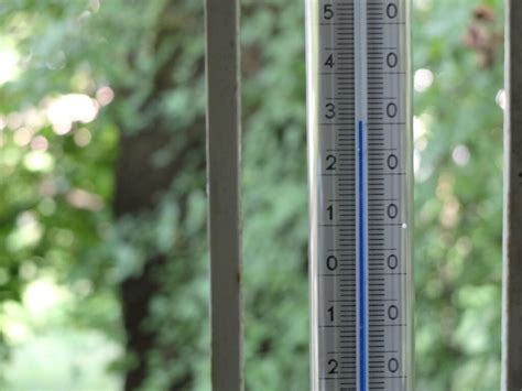 Zdjęcie termometru wskazującego wysoką temperaturę na tle szwedzkiego krajobrazu