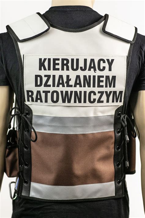 Schemat budowy kamizelki KDR z zaznaczonym rozmieszczeniem kieszeni na radiostację, latarkę i dokumenty.