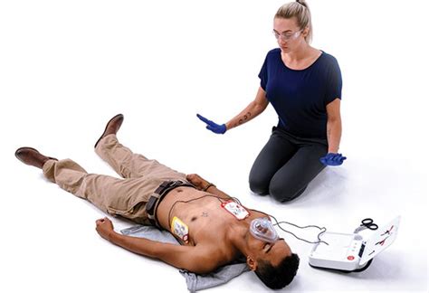 Photo of a First Responder volunteer using an AED