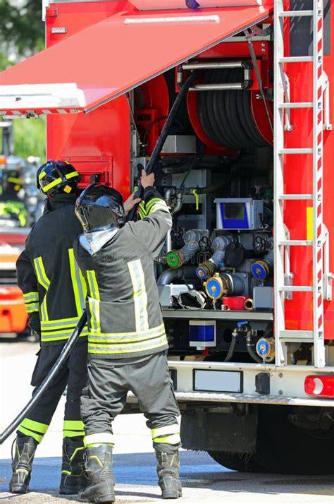 Thematic photo of firefighters with a red fire hose during an operation