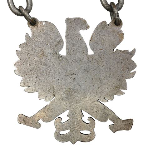 Thematic photo of an early PRL firefighter's eagle on a uniform cap or emblem