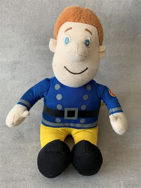 Large plush toy of Fireman Sam, sitting and showing its details.