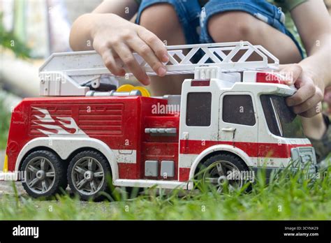 Thematic photo of a child playing with a fire truck