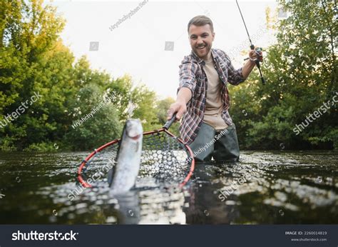 Thematic photo of a person fishing on a quiet pond