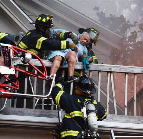 police officers rescuing elderly people from a smoky apartment building