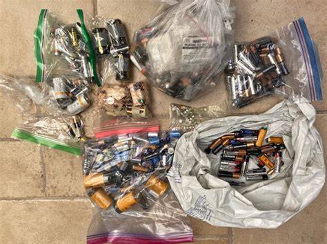 Photo of OSP members collecting batteries or displaying collected batteries