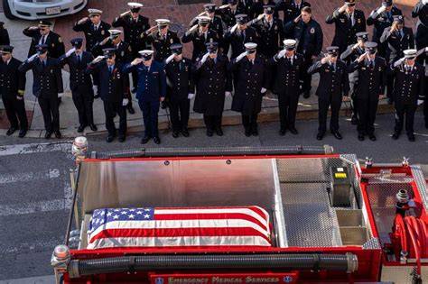 Thematic photo of firefighters in dress uniform at a funeral