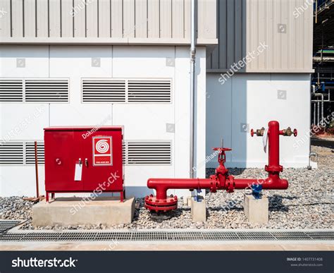Thematic photo of a red fire hydrant cabinet in a building corridor.
