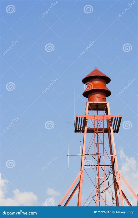 Thematic photo of a fire station with a siren on the roof, under a clear sky