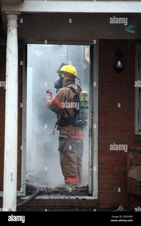 Thematic photo of firefighters extinguishing a house fire
