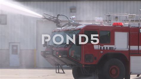 Thematic photo of airport fire truck spraying water foam