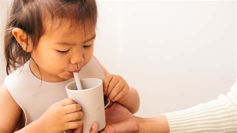 Photo of a child drinking from a straw