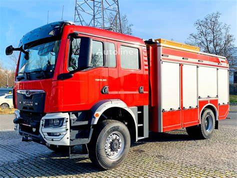 Detailed photo of a MAN TGM 18.320 4x4 Wawrzaszek fire truck with visible equipment compartments