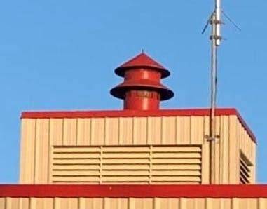 Thematic photo of an OSP fire station with a siren on the roof, perhaps against a blue sky.