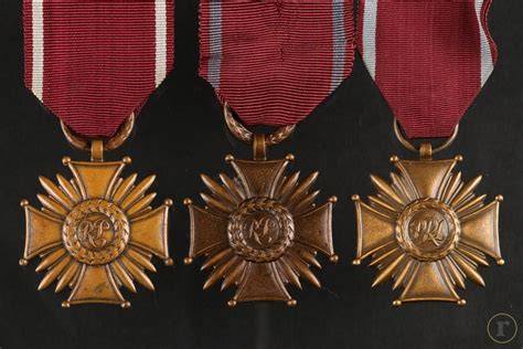 Graphic representation of the Polish Cross of Merit (Krzyż Zasługi) in its three grades