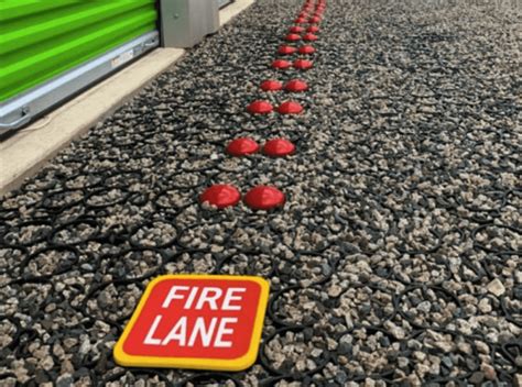 Thematic photo of a fire engine on a designated fire road next to a building
