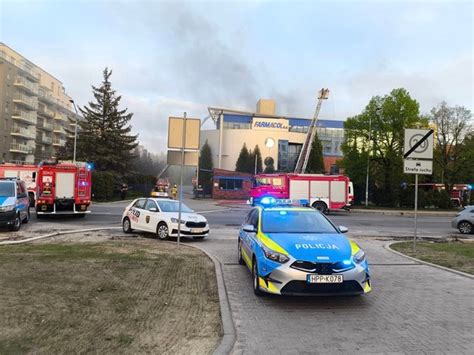 zdjęcie miejsca pożaru z policyjną taśmą, służby dochodzeniowe