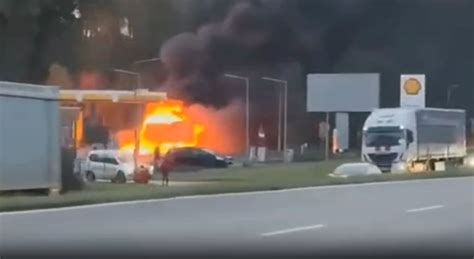 Zdjęcie płonącego busa na tle drogi krajowej lub widok na busa po akcji gaśniczej