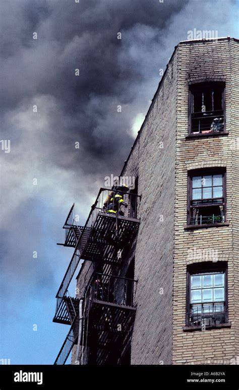 Thematic photo of a burning tenement building with firefighters working