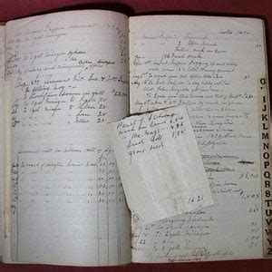 Photo of an open traditional OSP membership book with handwritten entries