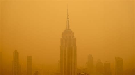 Thematic photo of a skyscraper in New York with smoke emanating from the roof
