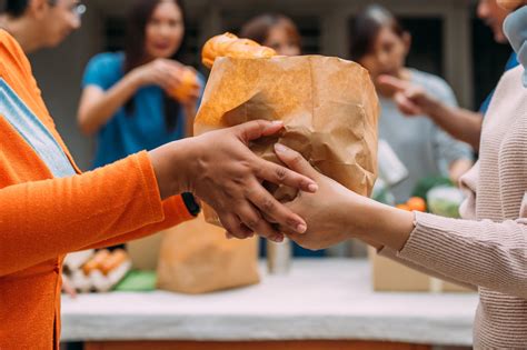 Infographic or photo showing food parcels being distributed to people