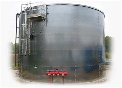 Thematic photo of a large fire protection tank against the background of a modern industrial building