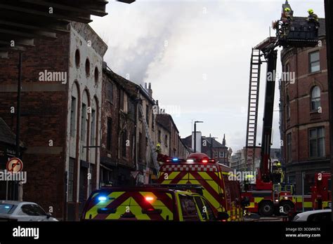 Thematic photo of emergency services at a fire scene with a building