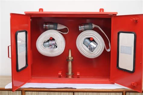 Thematic photo of a red internal hydrant cabinet on a wall in a public building