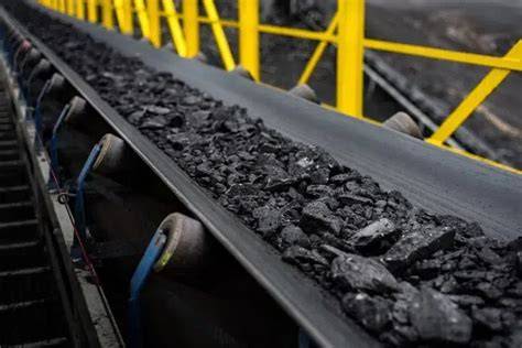 Thematic photo of a coal mine conveyor belt after a fire incident, with firefighters present