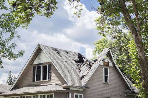 Photo of a house after a fire, showing damage to the roof or windows