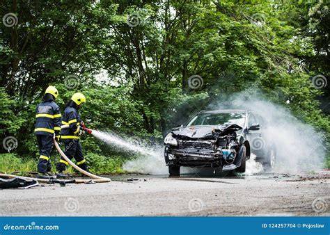 Photo of firefighters extinguishing a burning car