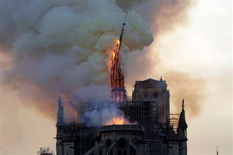 The Notre-Dame Cathedral engulfed in flames, a dramatic wide shot