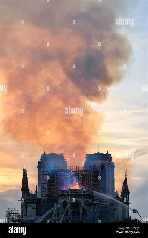 Firefighters battling the blaze on the roof of Notre-Dame Cathedral