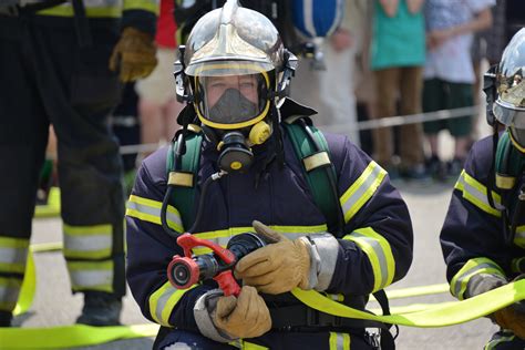 Photo of firefighters in respiratory protection gear extinguishing a fire