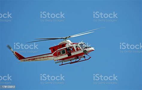 patrol helicopter of firefighters in blue sky over a fire