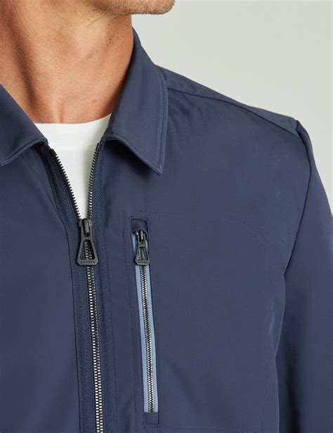 Detailed close-up of jacket features: pockets, zippers, collar