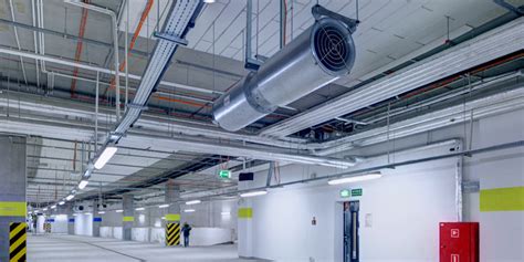 Thematic photo of a large underground car park with visible ventilation ducts and smoke detectors