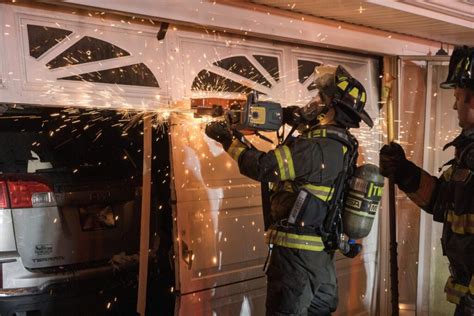 Thematic photo of a garage fire with firefighters in action