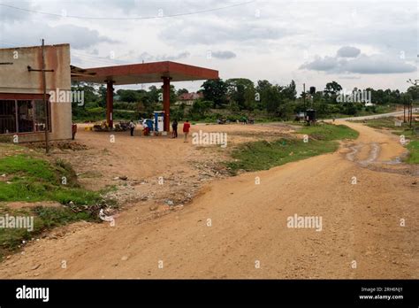 Thematic photo of a damaged, unpaved yard in front of a fire station with puddles