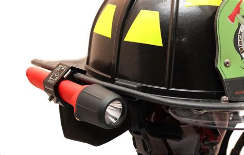 Thematic photo of a firefighter with a helmet-mounted flashlight during an rescue operation in low light conditions
