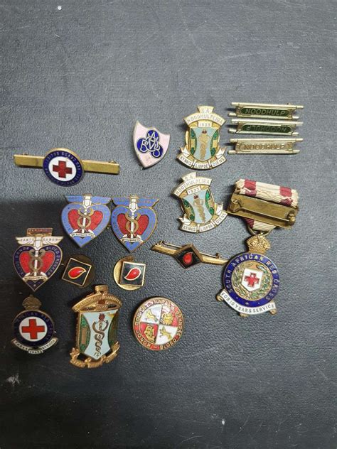 Thematic photo of various resin-poured pins and badges, including one for uniformed services or a fire department.