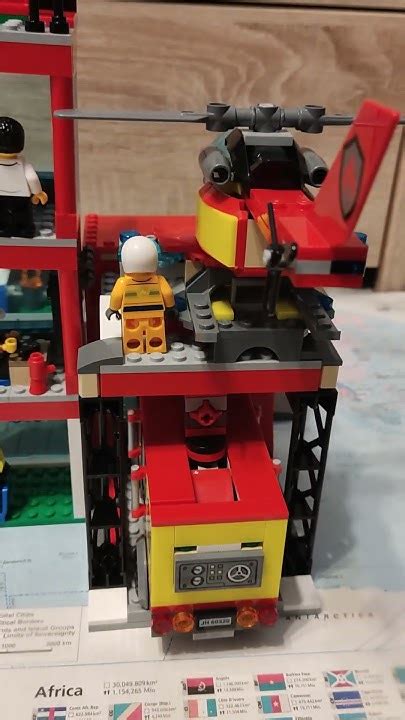 Widok na nowoczesną remizę strażacką LEGO City z przeszklonymi ścianami i lądowiskiem dla helikopterów