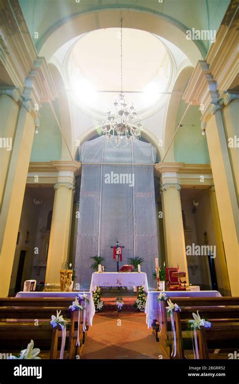 Photo of a church interior during a Mass or an external view of the church in Ulanów