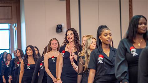Thematic photo of OSP ceremony with people proudly wearing pins and emblems