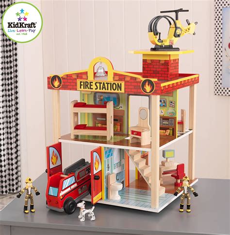 Children playing with a Kidkraft fire station, engaging in role-play